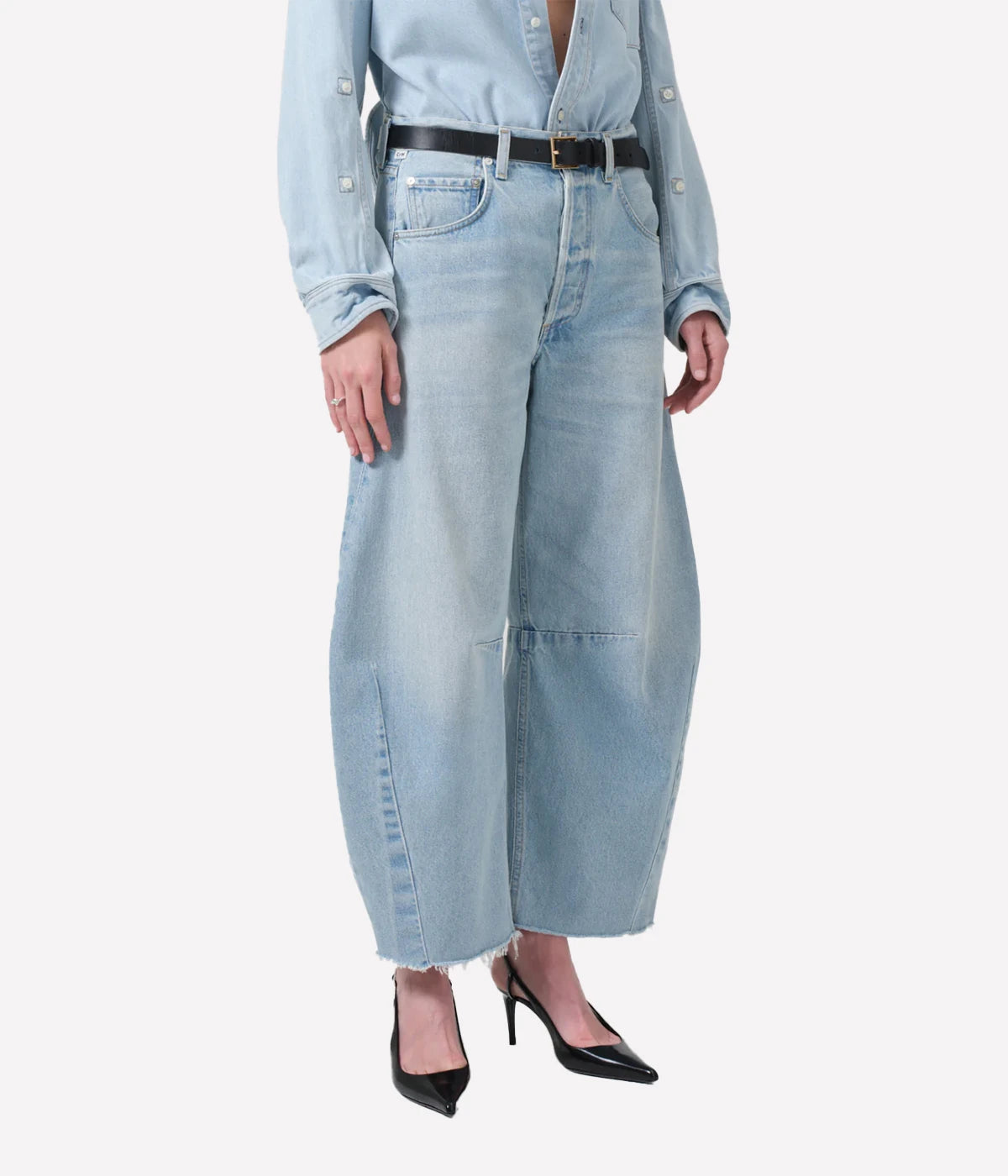 ALT Text: Light indigo cropped jeans with a curved wide-leg silhouette and frayed hems.