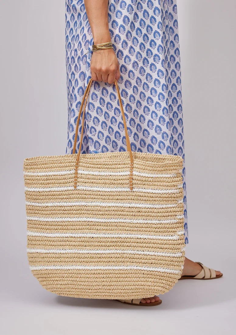 ALT text: A natural white striped tote bag by Hat Attack, featuring handwoven paper straw material and sturdy shoulder straps.