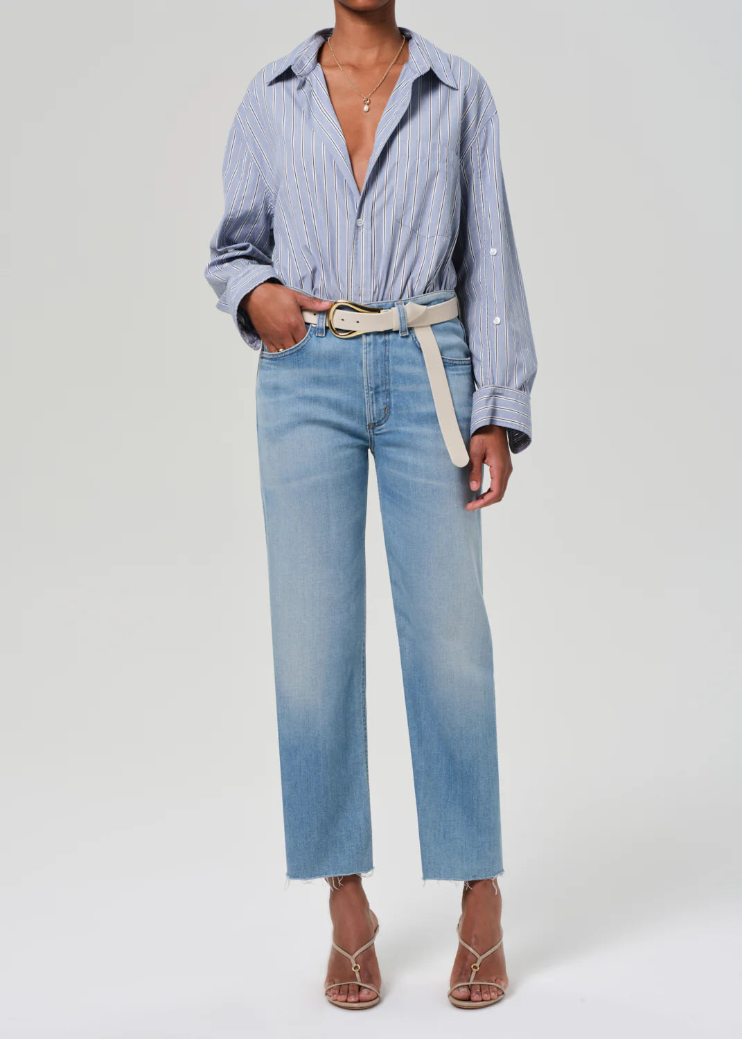 ALT text: High-rise straight-leg jeans in light indigo with fading and subtle whiskering.