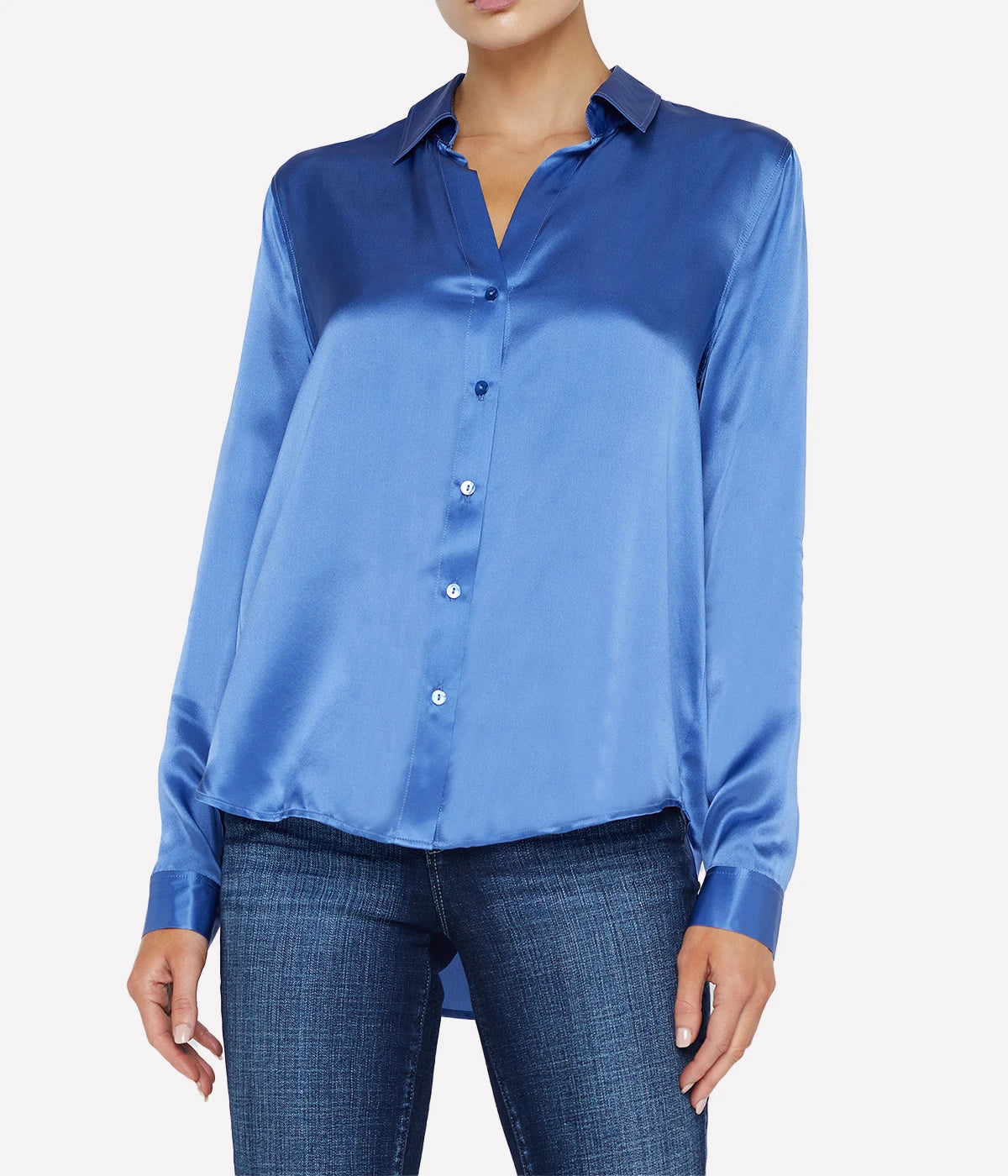 ALT text: Long-sleeve silk button-down blouse styled with skinny black jeans and heels.