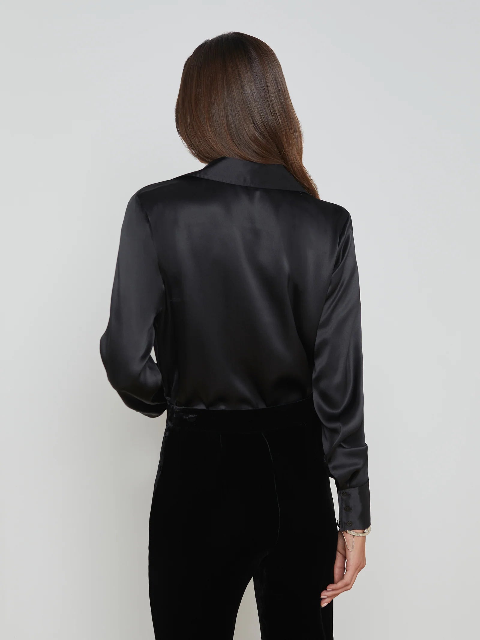 ALT text: Silk cowl neck blouse styled with a leather skirt and heels for a polished evening look.