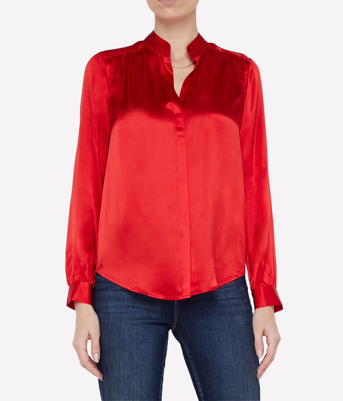 ALT text: Lava Red silk blouse with a band collar and hidden button placket, styled with tailored trousers