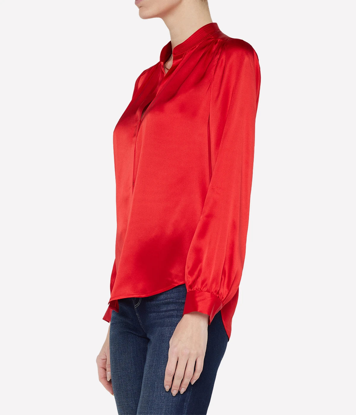 ALT text: Lava Red silk blouse with a band collar and hidden button placket, styled with tailored trousers