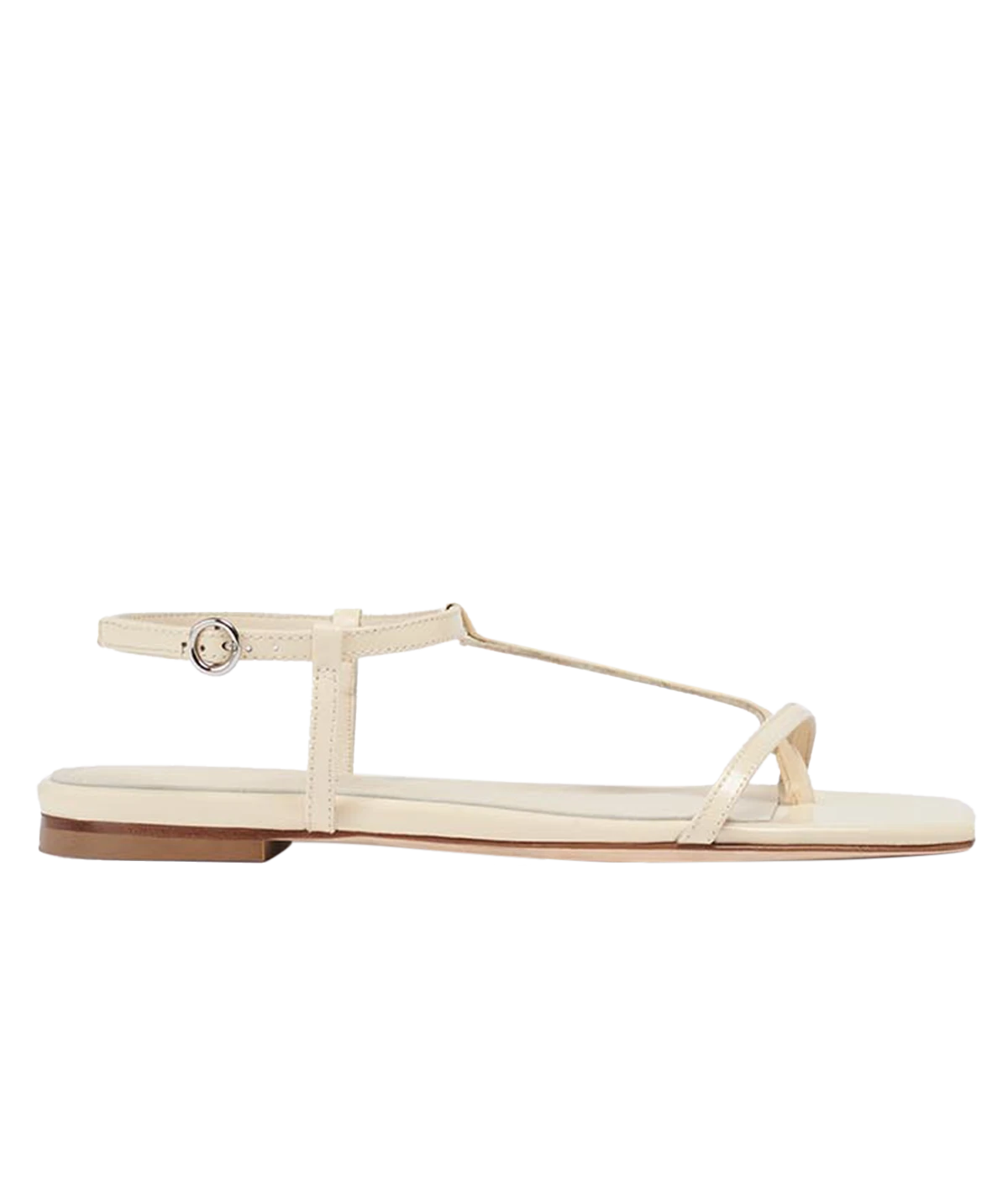 The Artis Thong Sandal in creamy Polido calf leather, featuring a sleek flat square toe design, perfect for versatile and sophisticated styling.