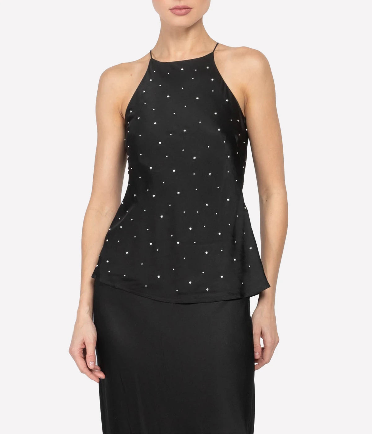 ALT text: Halter-style top with delicate spaghetti straps, slim silhouette, and playful polka dot details.