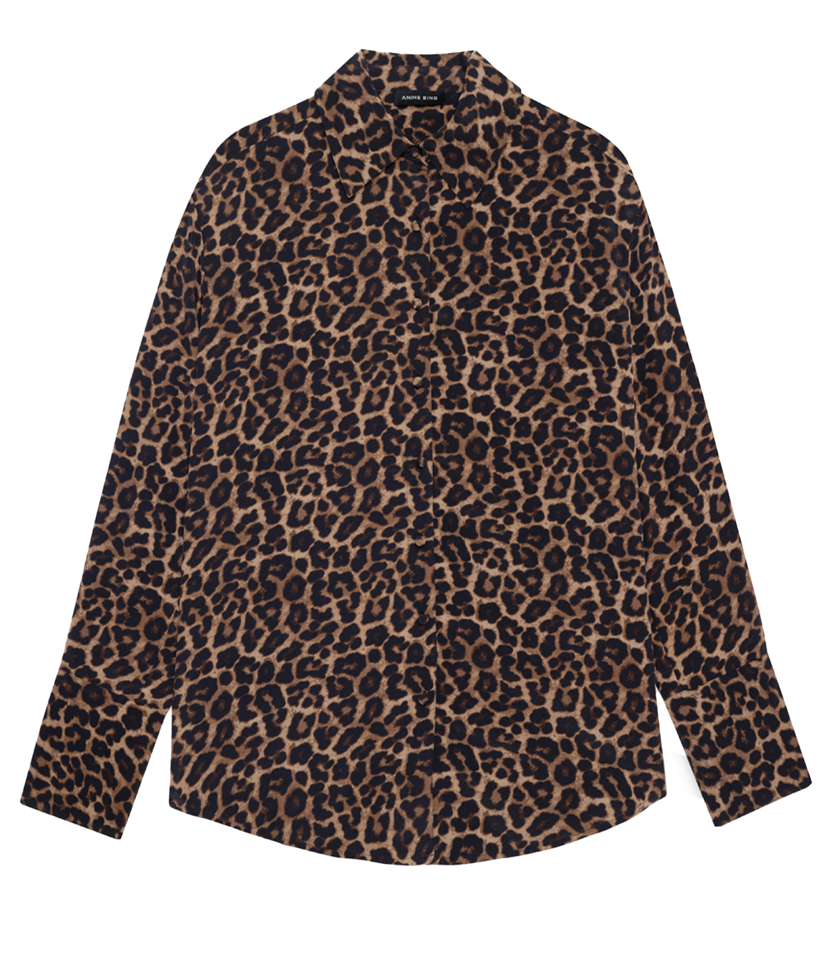 alt text: A lightweight button-up shirt with a bold leopard print, featuring a relaxed silhouette. Styled with black tailored trousers for a chic and polished look.