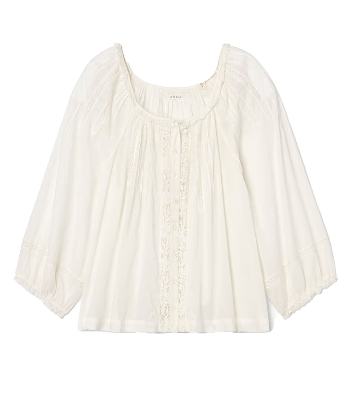 ALT text: Sheer cotton peasant top with lace insets, pintuck details, ruffled trim, and three-quarter-length sleeves.