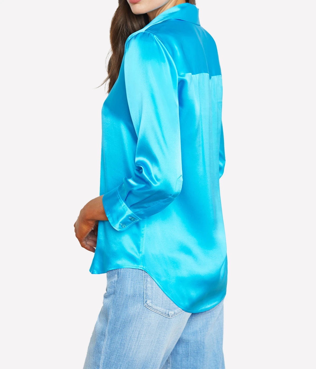 ALT Text: Dani Blouse in silk with a high-low hem, styled with jeans for a classic, polished look.