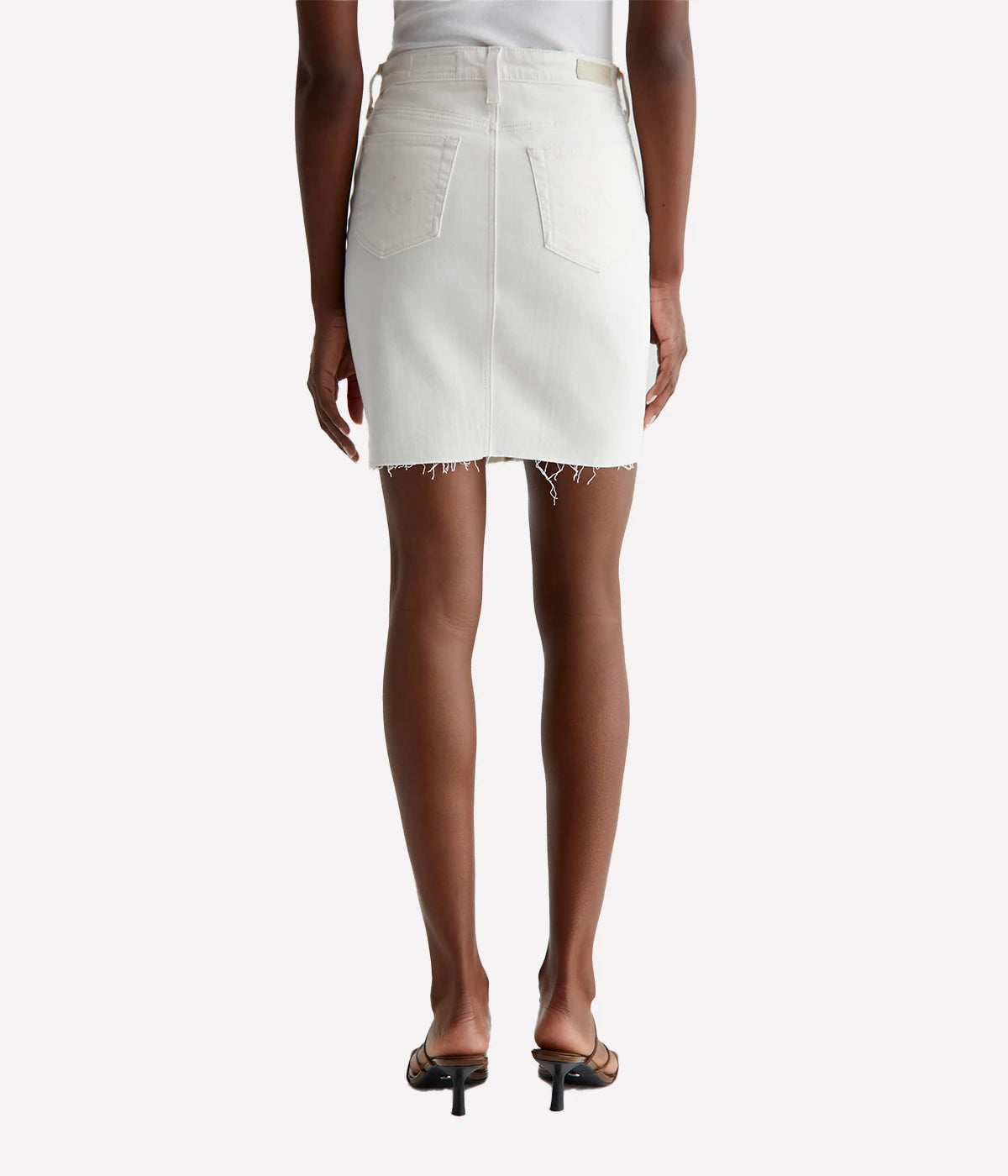 ALT Text: Erin Pencil Skirt in bright white denim with raw hem, figure-enhancing fit, and mid-thigh length.