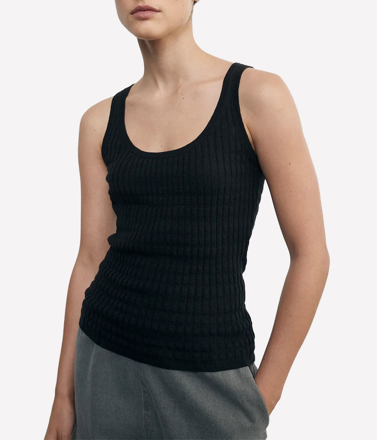 Lightweight sweater-knit tank with a scoop neckline and delicate pointelle stitch, made from a breathable linen-cotton blend.