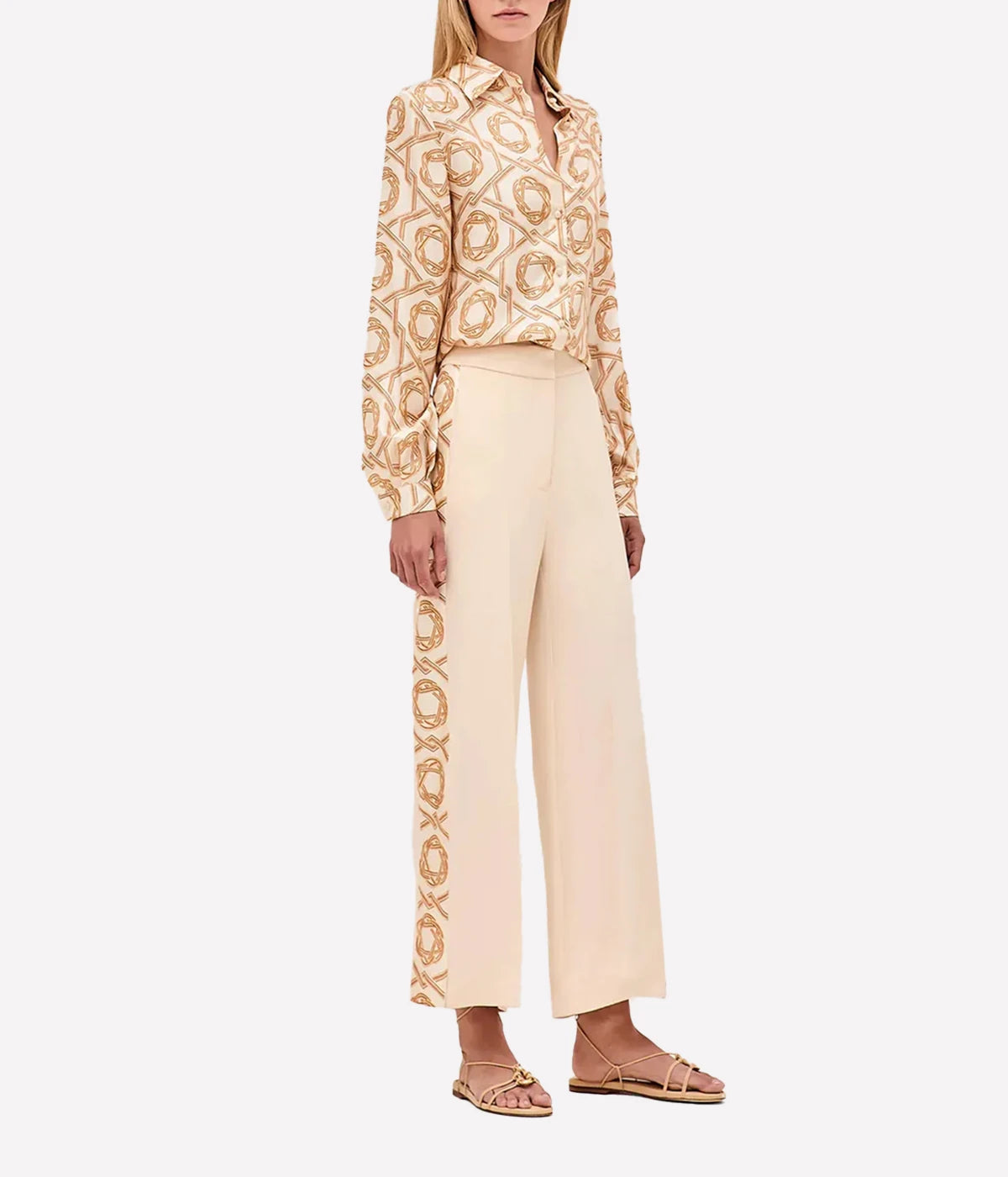 High-waisted wide-leg pants with side stripe detailing, styled with a fitted blouse and heeled boots.