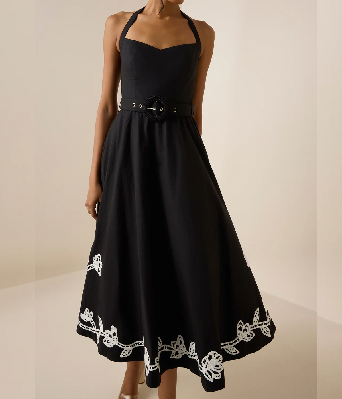 ALT text: Floral lace appliqué midi dress with halter neckline, on-seam side pockets, and a hook-and-eye side closure, styled for a bohemian chic look.