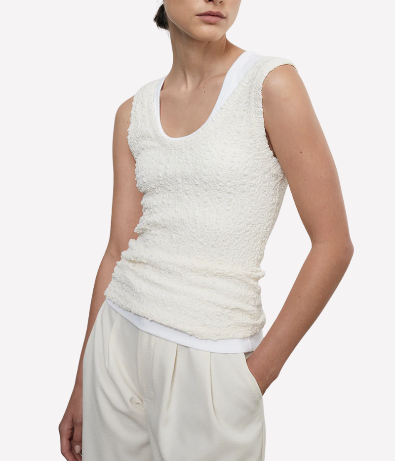 Lightweight tank with a delicately expandable texture and scoop neckline, styled for a relaxed and versatile look.