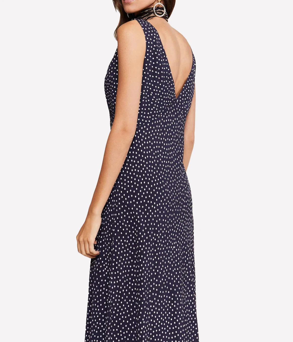 With a V-neck and V-back and a figure-lengthening empire waist and straight mid-length hem, the vintage inspired navy polka dot Sandrine dress combines lightweight elegance with timeless allure. A classic bias-cut slip, this bra friendly mid length dress with a V neck and V back will be a wardrobe staple for years to come.