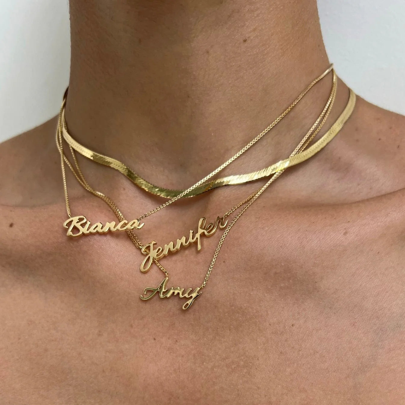 Customised name necklace in cursive lettering, shown with adjustable Italian box chain.